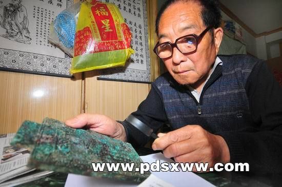 昨日上午，李大爷在家中研究发现的“宝贝”。本报记者禹舸摄 